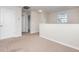Bright hallway with neutral walls and carpet, a window, and white doors offering a serene transition between rooms at 13417 Lake Monroe Pl, Riverview, FL 33579