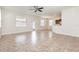 Spacious open living area featuring tiled floor with neutral paint, ceiling fan and natural light at 13417 Lake Monroe Pl, Riverview, FL 33579