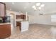 Open-concept living and kitchen area featuring tile flooring and abundant natural light at 13417 Lake Monroe Pl, Riverview, FL 33579