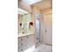 Bathroom features vanity with sink, a mirror, and a shower with glass door at 26187 Argentina Dr, Punta Gorda, FL 33983