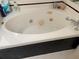 Jetted bathtub has black and white tiled siding at 26187 Argentina Dr, Punta Gorda, FL 33983