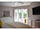 Bright bedroom features sliding glass doors to the pool area and neutral decor at 26187 Argentina Dr, Punta Gorda, FL 33983