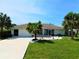 Charming single-story home featuring a well-manicured lawn and inviting curb appeal at 26187 Argentina Dr, Punta Gorda, FL 33983