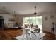Bright living room with dining area, wood floors, and sliding glass doors at 26187 Argentina Dr, Punta Gorda, FL 33983
