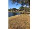 Scenic view of a calm pond surrounded by lush greenery and birds on the bank at 26187 Argentina Dr, Punta Gorda, FL 33983