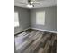 Bedroom with hardwood floors, neutral paint, a ceiling fan, and plenty of natural light at 3615 E Grove St, Tampa, FL 33610