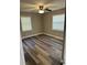Bedroom with hardwood floors, neutral paint, a ceiling fan, and plenty of natural light at 3615 E Grove St, Tampa, FL 33610