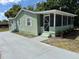 Charming home with a screened porch and freshly painted exterior and driveway at 3615 E Grove St, Tampa, FL 33610