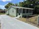 Charming home with a screened porch and freshly painted exterior and driveway at 3615 E Grove St, Tampa, FL 33610