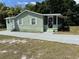 Sweet, cottage-like home with screened-in front porch and a fresh and updated appearance at 3615 E Grove St, Tampa, FL 33610