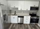 Bright kitchen with stainless steel appliances and modern cabinetry and new floor at 3615 E Grove St, Tampa, FL 33610