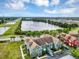 Aerial view of green condo buildings overlooking lake and trees, showcasing the property's location at 10520 Windsor Lake Ct # 10520, Tampa, FL 33626