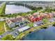 A high-angle view of townhouses, parking areas, and lakes within the community at 10520 Windsor Lake Ct # 10520, Tampa, FL 33626