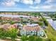 An aerial view of condo buildings and lakes showcases the community's design and waterfront setting at 10520 Windsor Lake Ct # 10520, Tampa, FL 33626