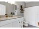 Bright bathroom featuring a marble countertop, white cabinetry, and decorative shelves with plants at 10520 Windsor Lake Ct # 10520, Tampa, FL 33626