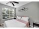 Bedroom with a large window, ceiling fan, and neutral decor at 10520 Windsor Lake Ct # 10520, Tampa, FL 33626