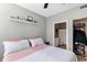 Bedroom with a view into an en-suite bathroom, ceiling fan, and neutral decor at 10520 Windsor Lake Ct # 10520, Tampa, FL 33626