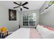 Bedroom with a large window, ceiling fan, and neutral decor at 10520 Windsor Lake Ct # 10520, Tampa, FL 33626