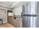 The kitchen has a stainless steel refrigerator, modern appliances, and light wood cabinetry at 10520 Windsor Lake Ct # 10520, Tampa, FL 33626