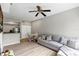 Bright living room featuring modern ceiling fan, wood-look floors, and comfortable sofa at 10520 Windsor Lake Ct # 10520, Tampa, FL 33626
