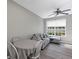 Living room featuring a comfortable gray couch, dining table, and natural light from the window at 10520 Windsor Lake Ct # 10520, Tampa, FL 33626
