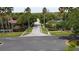 Street view of Cambridge II community entrances with brick signage, palm trees, and a well-maintained landscape at 5701 Ainsworth W Ct, Tampa, FL 33647