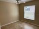 Bedroom features neutral walls, tile floors, and a window with white blinds for natural light at 1210 Etchfield Cir, Brandon, FL 33511