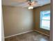 Bright bedroom with tile flooring, a ceiling fan, and a window for natural light at 1210 Etchfield Cir, Brandon, FL 33511
