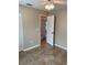 View of the home's tile-floored bedroom, showing the closet and a doorway to another room at 1210 Etchfield Cir, Brandon, FL 33511