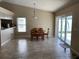 Bright dining area features tile flooring, sliding glass doors, and modern chandelier lighting at 1210 Etchfield Cir, Brandon, FL 33511