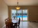 Dining room with a view to a pool through sliding glass doors at 1210 Etchfield Cir, Brandon, FL 33511