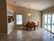 Dining area featuring a light fixture and sliding glass doors offering a view of the backyard at 1210 Etchfield Cir, Brandon, FL 33511
