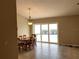 Dining room featuring a light fixture and sliding glass doors offering a view of the pool and patio at 1210 Etchfield Cir, Brandon, FL 33511