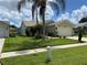 Exterior front view of home with manicured lawn, landscaping, and a two-car garage at 1210 Etchfield Cir, Brandon, FL 33511