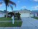Charming single-story home with a well-manicured lawn, lush landscaping, and a two-car garage at 1210 Etchfield Cir, Brandon, FL 33511
