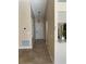Inviting hallway with tile flooring and neutral paint leads to the front door and living areas at 1210 Etchfield Cir, Brandon, FL 33511