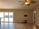 Bright living room with tile flooring, ceiling fan, and sliding glass doors offering a view of the pool at 1210 Etchfield Cir, Brandon, FL 33511