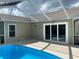 Outdoor pool area featuring a sparkling blue pool with ladder access and ample patio space at 1210 Etchfield Cir, Brandon, FL 33511