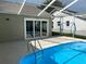 Enclosed pool and patio with ladder access, screened enclosure, and beautiful outdoor space at 1210 Etchfield Cir, Brandon, FL 33511