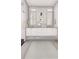 Bright bathroom featuring a double vanity, gold fixtures, and a stylish geometric rug at 25197 Delgado Dr, Punta Gorda, FL 33955
