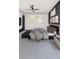 Modern bedroom featuring a platform bed with decorative pillows, a ceiling fan, and ample natural light at 25197 Delgado Dr, Punta Gorda, FL 33955