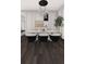 Contemporary dining room with marble table, modern chairs, chandelier, and stylish artwork at 25197 Delgado Dr, Punta Gorda, FL 33955
