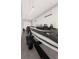 Spacious garage with a boat on a trailer, a truck, and a motorcycle, providing ample storage at 25197 Delgado Dr, Punta Gorda, FL 33955