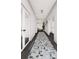 Inviting hallway with wood floors, a stylish rug, and views into adjacent living spaces at 25197 Delgado Dr, Punta Gorda, FL 33955