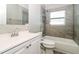 This bathroom features a shower/tub combo and a vanity with storage at 1453 Thames Ln, Clearwater, FL 33755