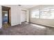 This bedroom has neutral paint and carpet and a double-door closet with built-in shelving at 1453 Thames Ln, Clearwater, FL 33755