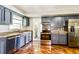 Modern kitchen with stainless steel appliances, granite countertops, and mosaic backsplash at 1453 Thames Ln, Clearwater, FL 33755