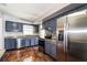 Modern kitchen with stainless steel appliances, granite countertops, and mosaic backsplash at 1453 Thames Ln, Clearwater, FL 33755