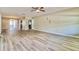Bright and airy living room featuring laminate floors, ceiling fan, and an open layout at 1453 Thames Ln, Clearwater, FL 33755