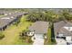 Aerial view of a home with a landscaped yard, screened pool, and community surroundings at 10735 Spring Tide Way, Parrish, FL 34219